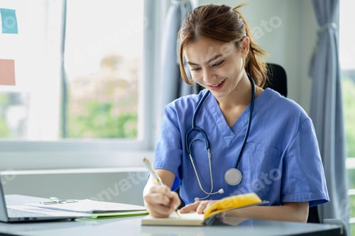 Preview: Beautiful young female doctor in medical clothes sits and works in a hospital office, a medical prof