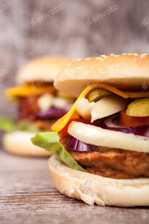 Preview: Delicious tasty burgers on wooden background
