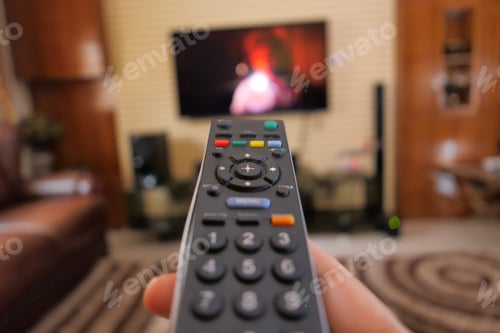 Preview: close up of women hand holding tv remote.
