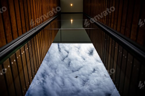 Preview: Low angle shot of a tall building and an airplane
