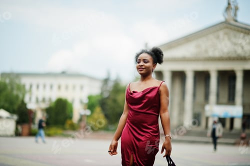 Preview: Black model in red silk dress.