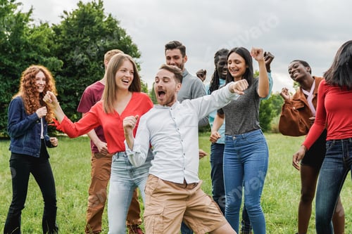Preview: Multiethnic group of friends having fun dancing together outdoor during summer vacations