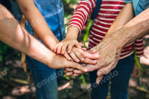 Preview: Family stacking hands as a team