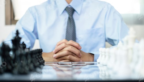 Preview: hand of businessmen moving chess in competition shows leadership, followers and business success
