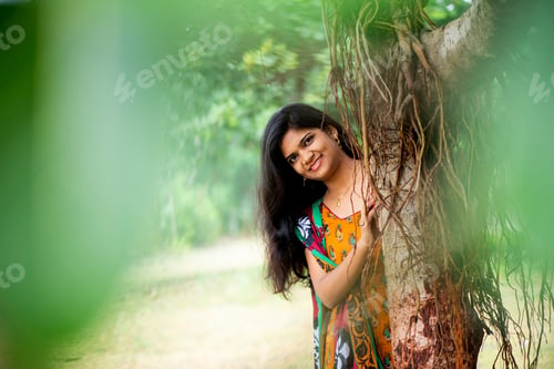 Preview: Happy woman near banyan tree