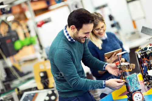 Preview: Young attractive students of mechatronics working on project