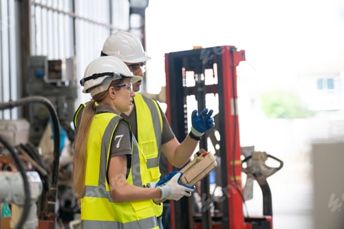 Preview: Robotics engineer working on maintenance of modern robotic arm in factory warehouse