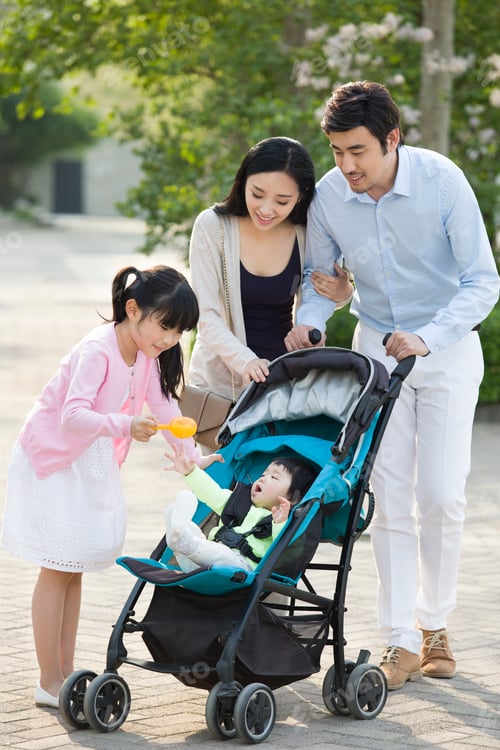 Preview: Young family taking a walk with baby in pram