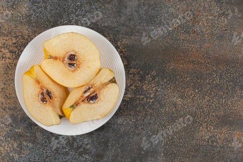 Preview: Slices of yellow quince on white plate
