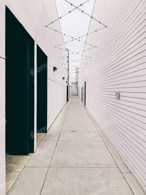 Preview: Long walkway surrounded by tall white walls