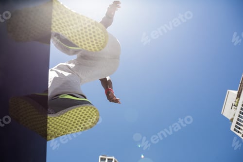 Preview: Athletic man about to do a back flip in the city