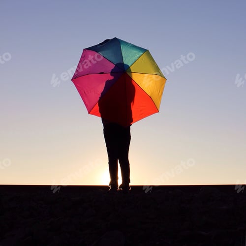 Preview: Person with a Colorful Umbrella at Sunset