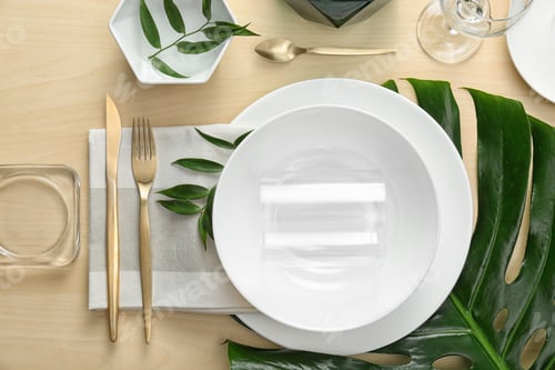 Preview: Elegant table setting with green tropical leaves, flat lay