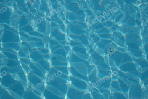 Preview: Sunlight patterns on azure pool tiles, serene and empty. Reflects growing interest in tranquil