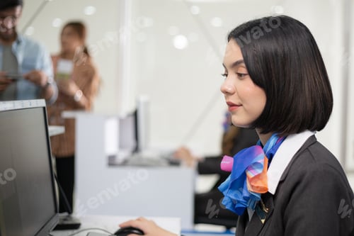 Preview: Woman officer sitting at check in counter desk at the airport