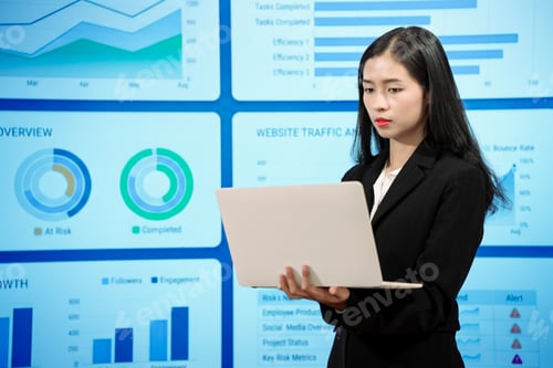 Preview: Asian businesswoman analyzing reports before digital dashboards evaluating import taxes consumer