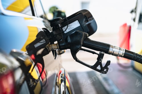 Preview: Pumping gasoline fuel in brown car at gas station