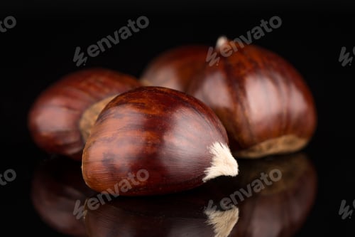 Preview: Chestnuts on a black reflective background