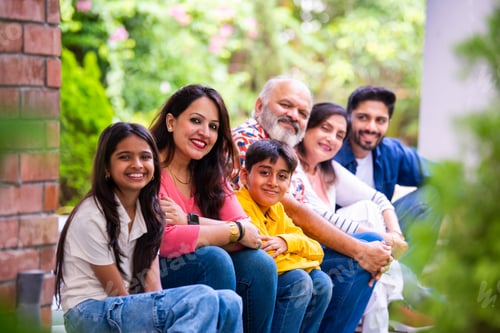 Preview: Indian family enjoying outdoor bonding time on steps during weekend relaxation