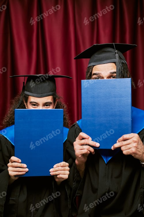 Preview: Portrait of Two Young Adult Multiethnic Graduates Posing in Photo Booth