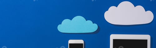Preview: top view of empty paper clouds near smartphone and digital tablet with blank screen isolated on