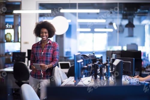 Preview: young black woman at her workplace in modern office African-Ame