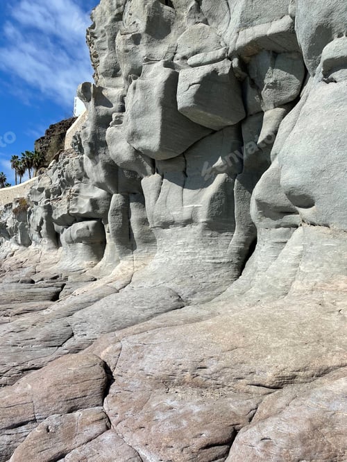 Preview: Eroded sandstone cliffs on a sunny coastline.