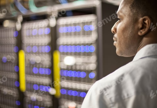 Preview: Black man technician doing diagnostic tests on computer servers in server farm.