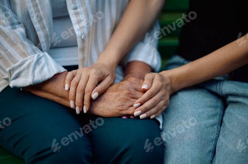 Preview: Granny and granddaughter on bench in summer park