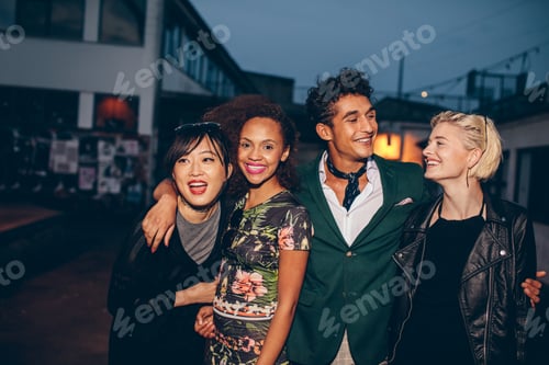 Preview: Friends walking down street in the evening
