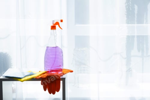 Preview: Window cleaning products are lying on the windowsillwith a rag, spray, detergent.