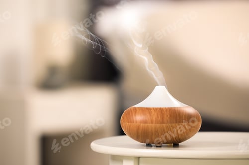 Preview: Modern essential oil diffuser on table indoors. Space for text