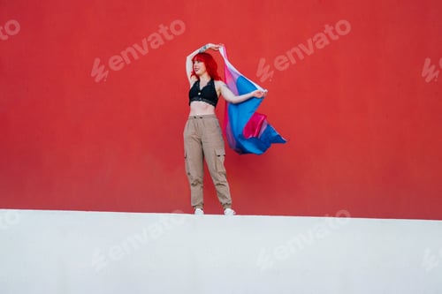 Preview: Beautiful shot of a female waving red and blue flag with a red background