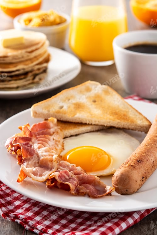Preview: Traditional American breakfast with fried egg,toast,bacon and sausage