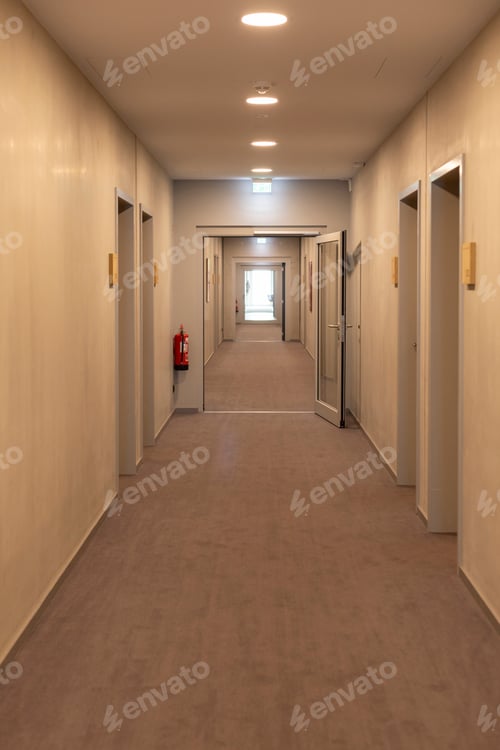 Preview: Clean and well-lit corridor features multiple doors along each side