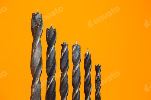 Preview: Drills for wood of different sizes for a drill on an orange background. Construction tool