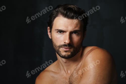 Preview: Young half-naked man posing and looking at camera