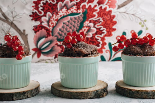 Preview: Three Chocolate cakes in the cup with currants and sugar glass.