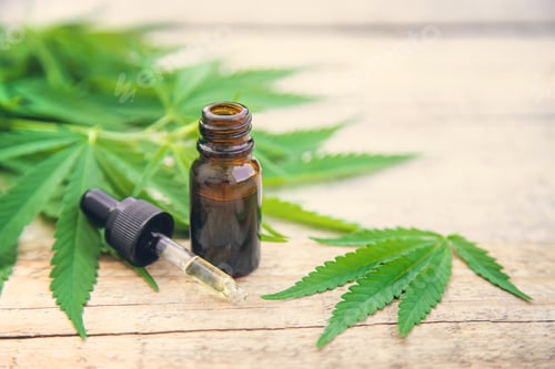 Preview: Cannabis extract in a small bottle. Selective focus.