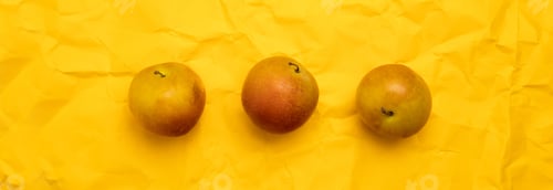 Preview: Delicious ripe organic plums on yellow background, copy space. Top view, flat lay