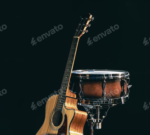 Preview: Acoustic guitar and snare drum on a black background isolated.