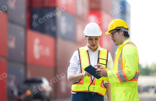 Preview: Portrait of Asian woman engineer and worker working with co-worker at overseas shipping container