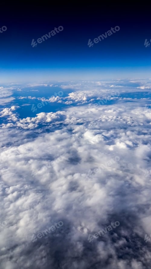 Preview: Wonderful view of cloudscape with clear blue sky from above.