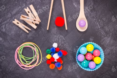 Preview: Colorful pompoms, balls and rubber erasers using for playing and development of kids motor skills