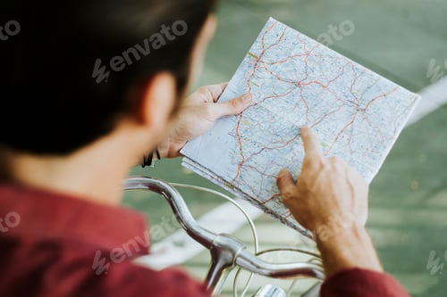 Preview: Cyclist checking on a map