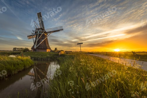 Preview: Wooden windmill canal cycling track at sunset