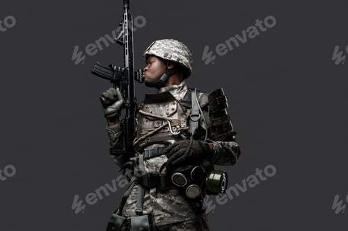 Preview: Army soldier of african ethnic with rifle against grey background