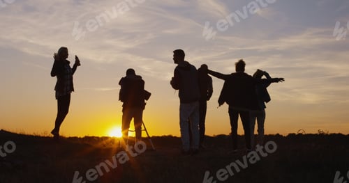 Preview: Medium Shot Of Friends Stargazing Together And Using A Professional Telescope At Sunset In Evening