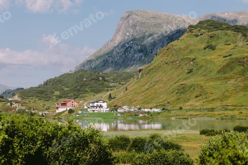 Preview: beautiful mountain village with lake and green hills