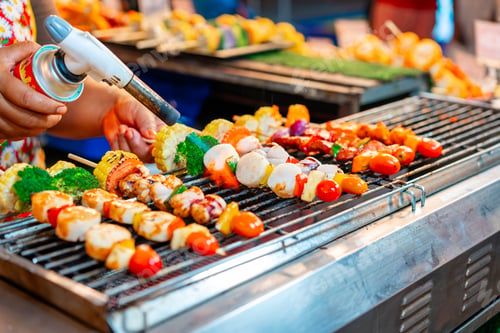 Preview: Chef using flame torch to burn scallop BBQ sticks at street food night market